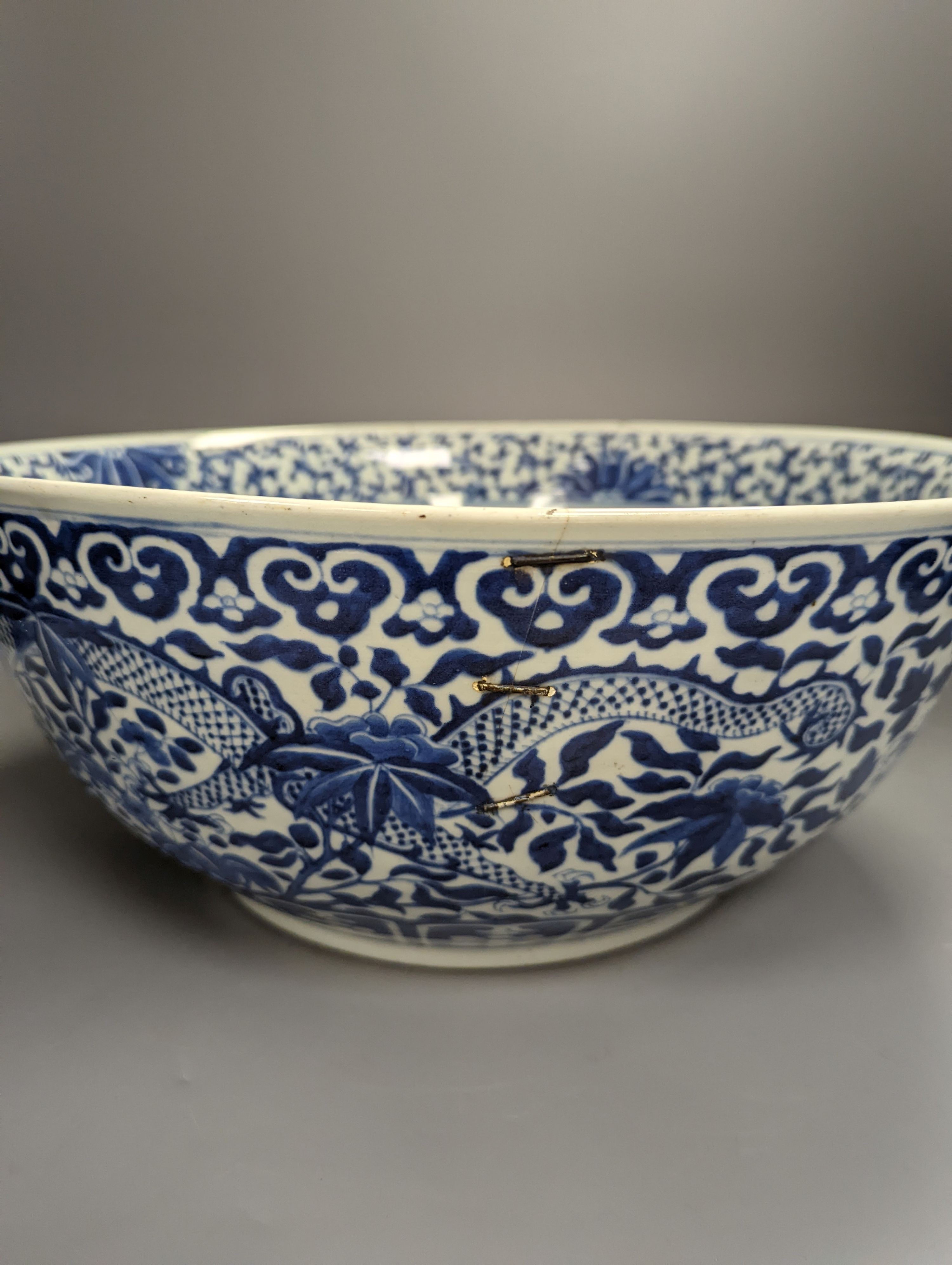 A large 19th century Chinese blue and white ‘dragon’ bowl (a.f.) 41cm